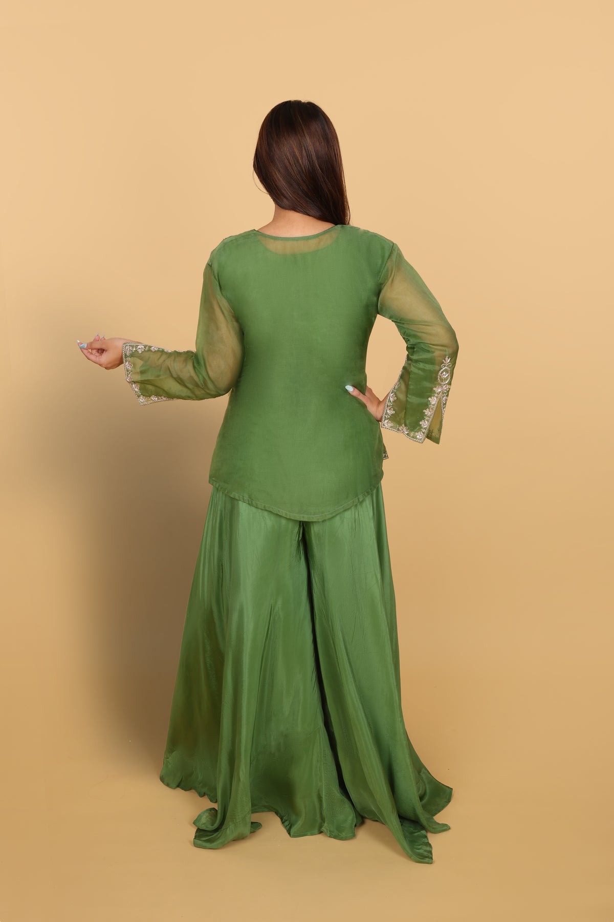 Green peplum top with bustier and umbrella palazzo