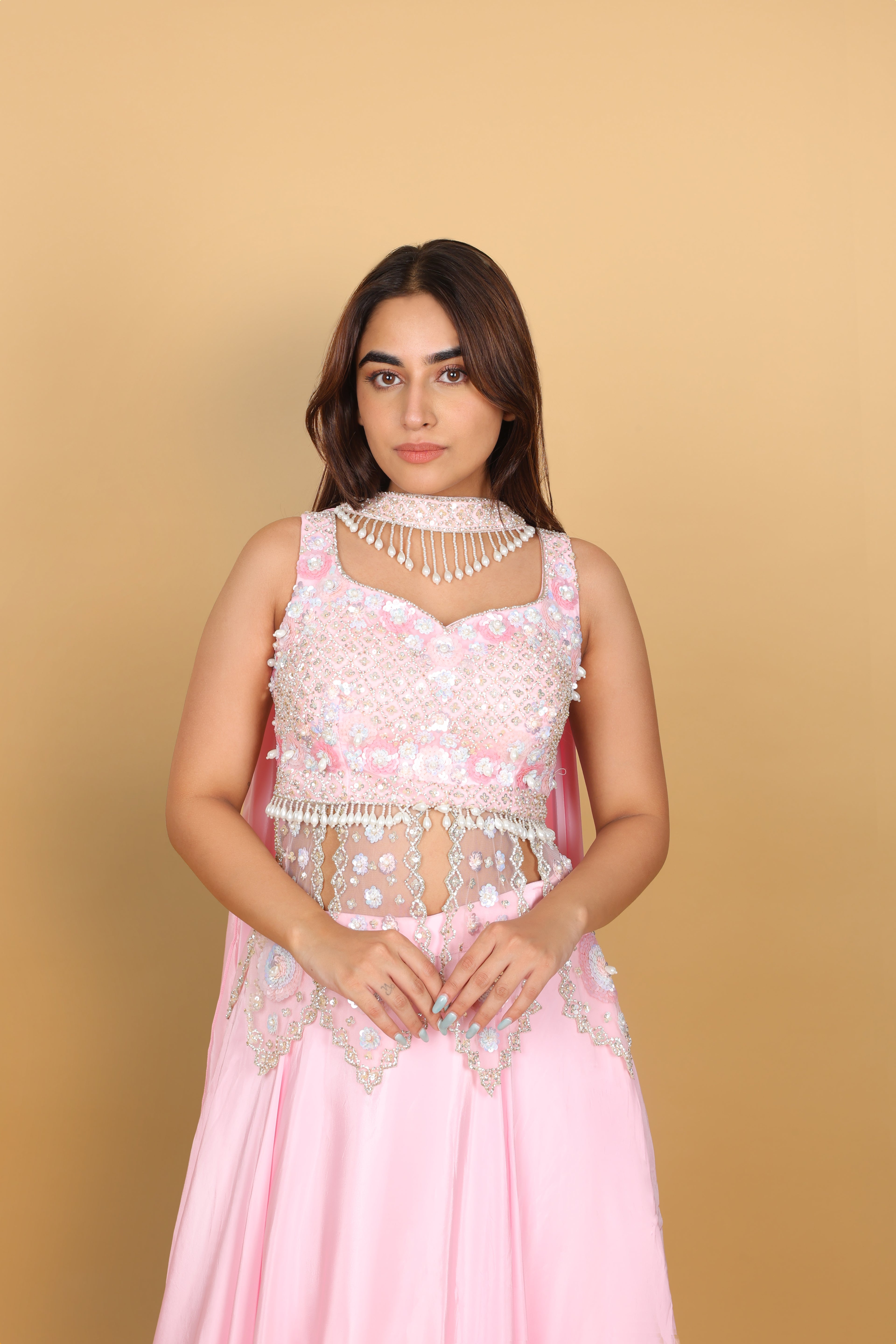 Baby-pink Indo-Western lehenga with peplum top and necklace-style dupatta