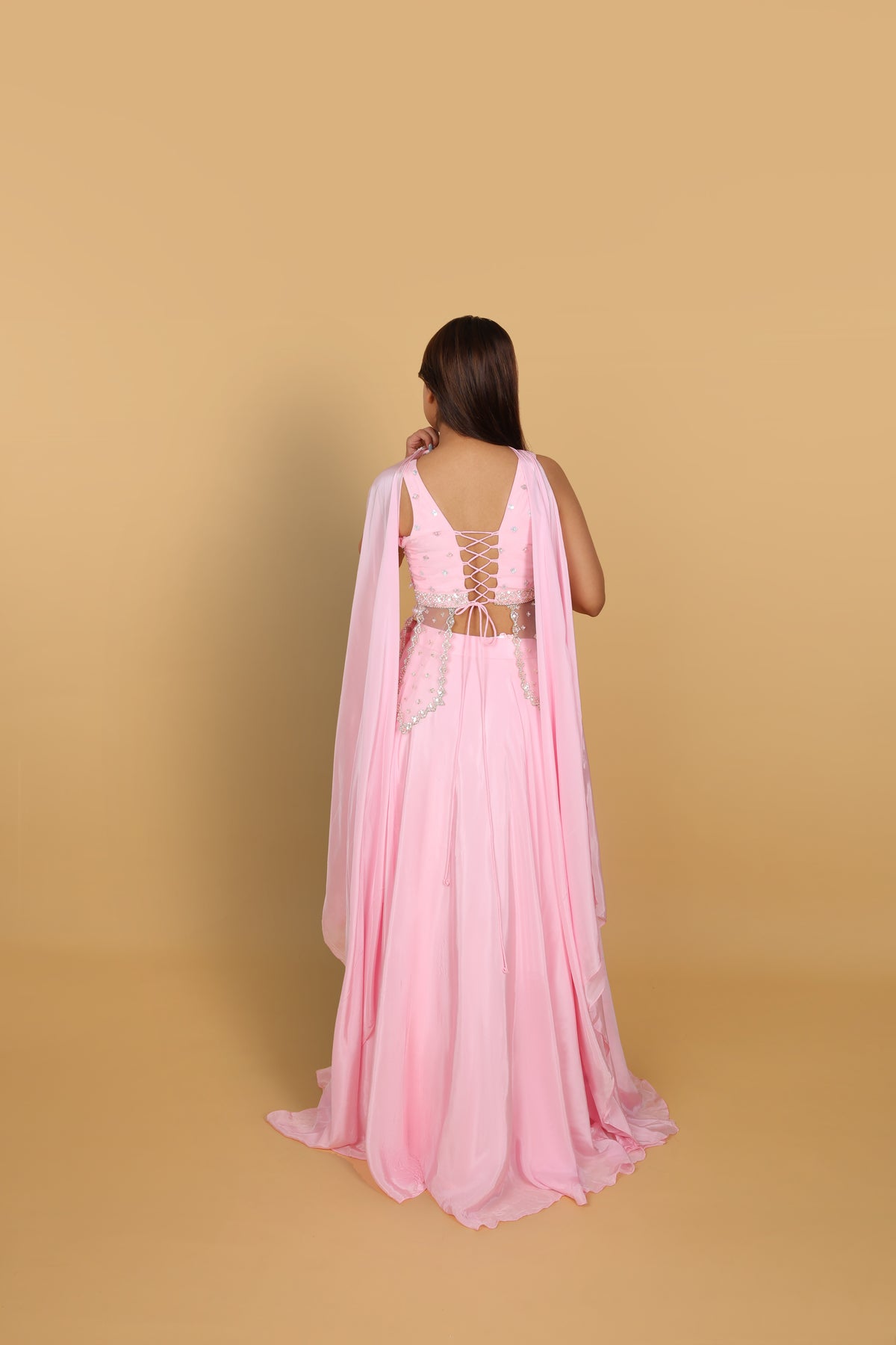 Baby-pink Indo-Western lehenga with peplum top and necklace-style dupatta