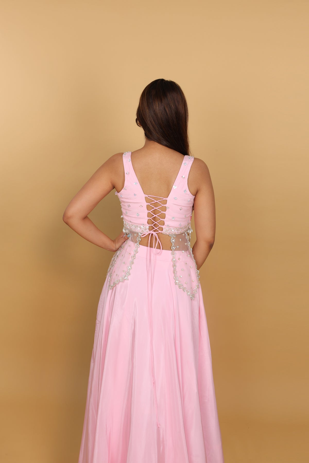 Baby-pink Indo-Western lehenga with peplum top and necklace-style dupatta
