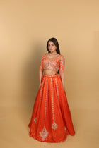 Orange box-pleated lehenga with a heavily worked blouse and dupatta
