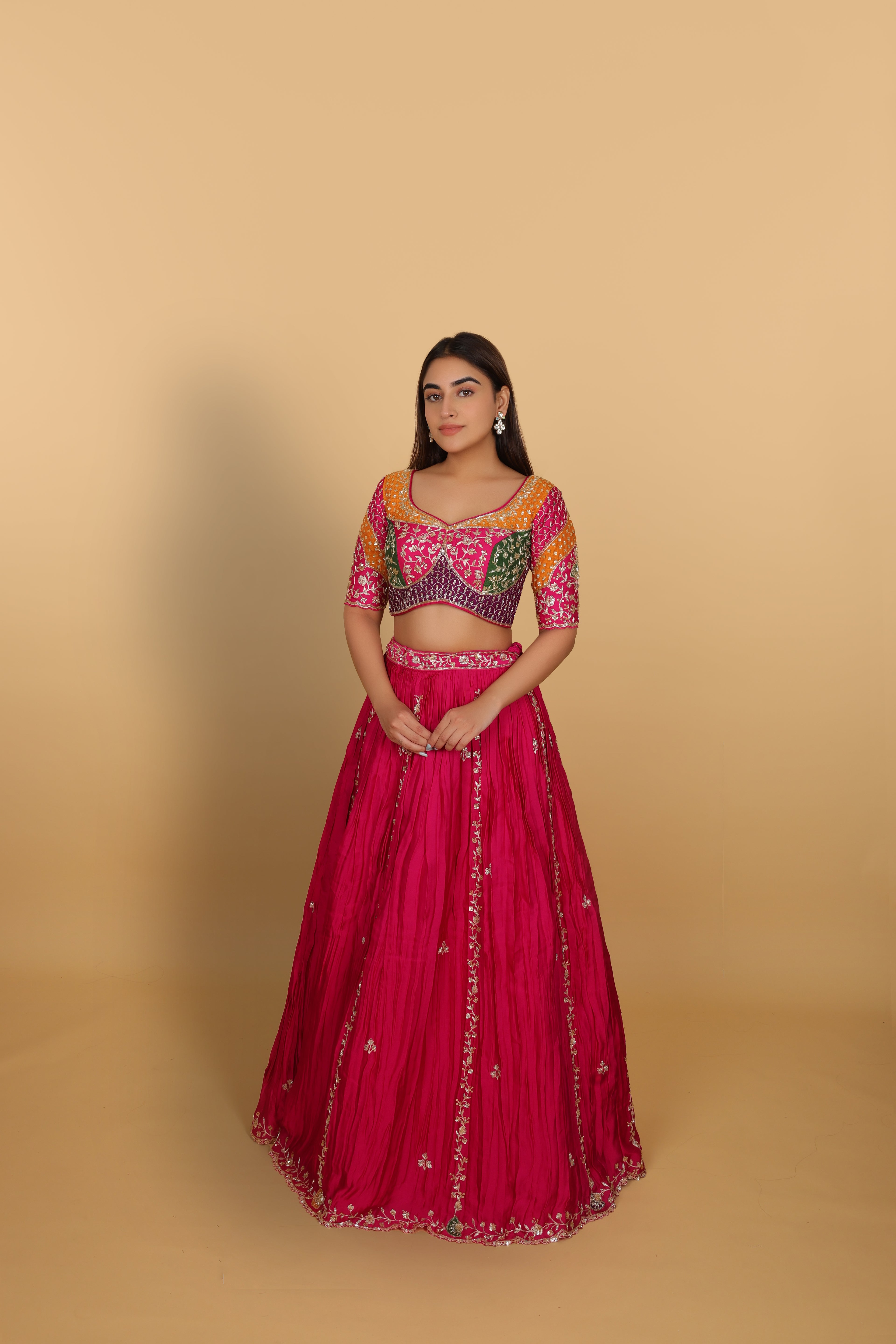 Magenta/Rani lehenga with a heavily worked multicoloured blouse and dupatta