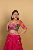 Magenta/Rani lehenga with a heavily worked multicoloured blouse and dupatta