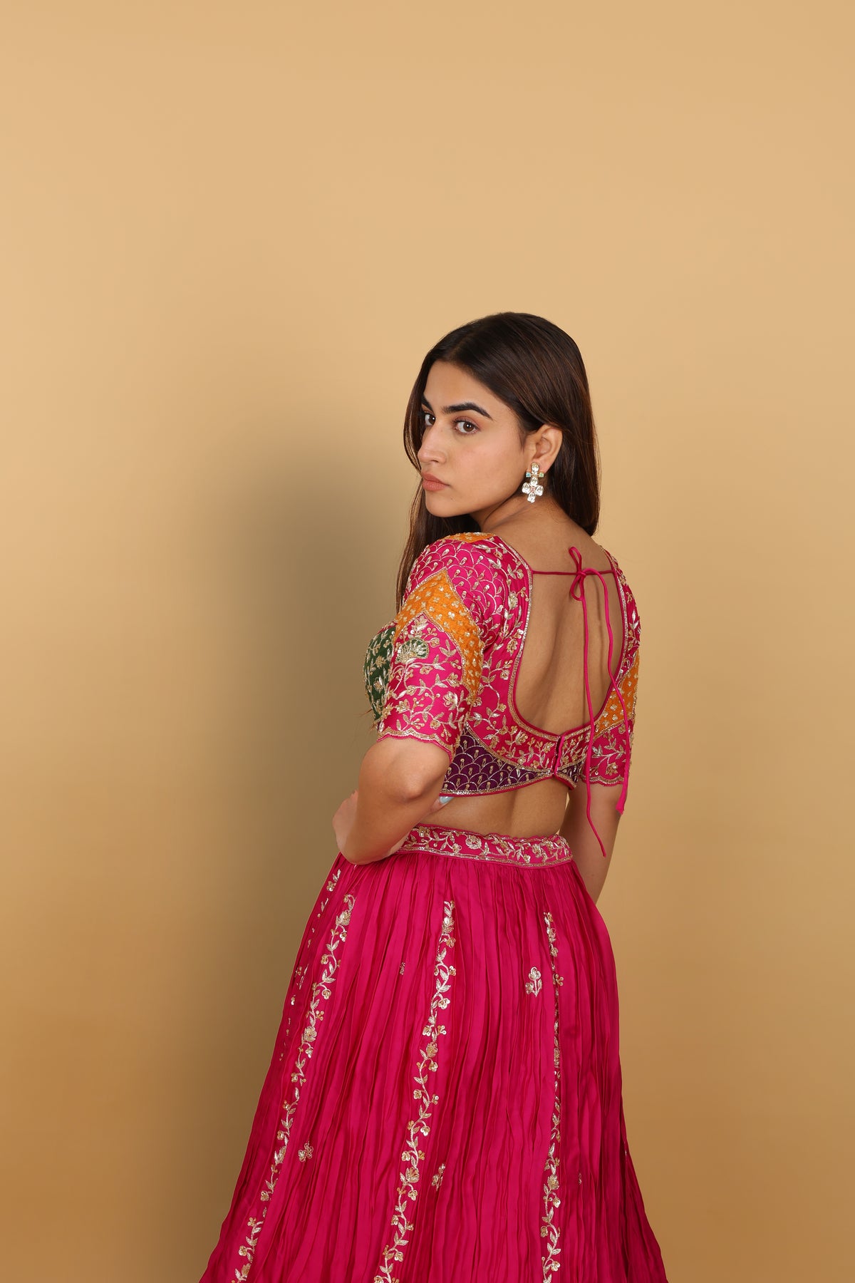 Magenta/Rani lehenga with a heavily worked multicoloured blouse and dupatta